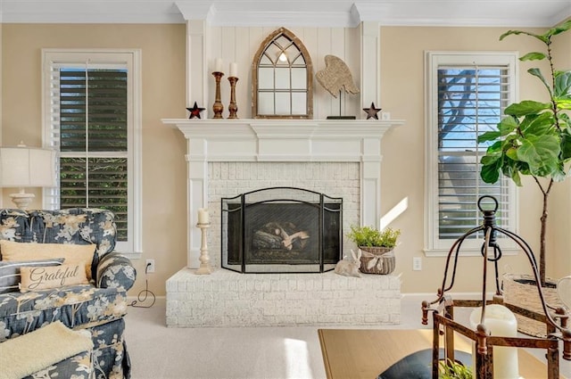 carpeted living area with a brick fireplace and ornamental molding