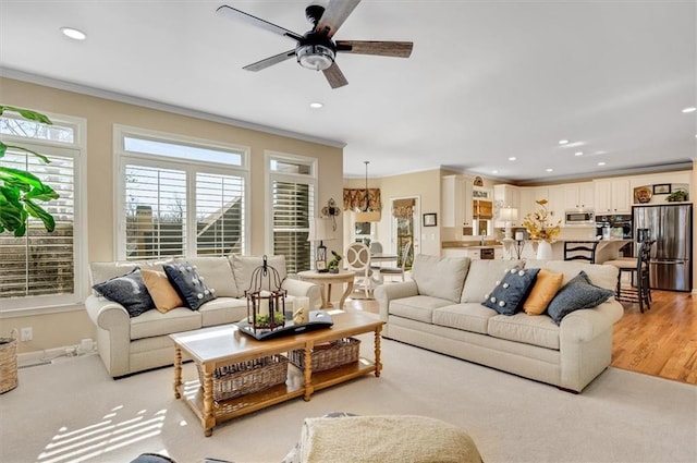 living room with ceiling fan, recessed lighting, and ornamental molding