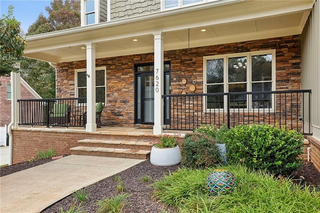 doorway to property featuring covered porch