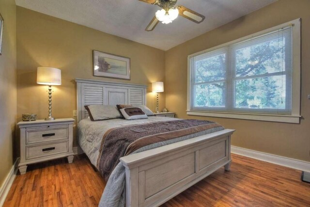 bedroom featuring ceiling fan and hardwood / wood-style flooring