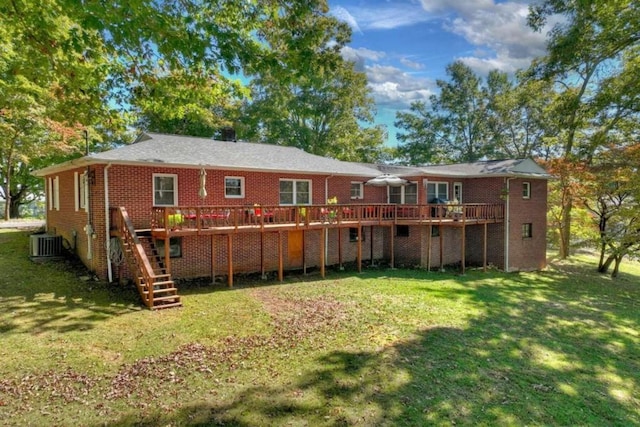 rear view of property with central AC, a deck, and a lawn