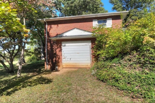 garage featuring a yard