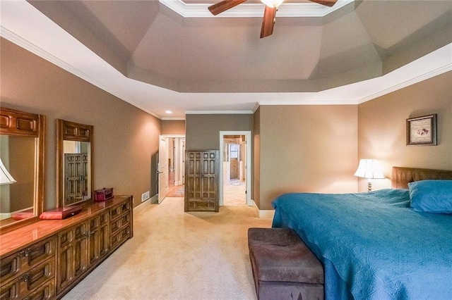 carpeted bedroom featuring ornamental molding, ceiling fan, and a raised ceiling