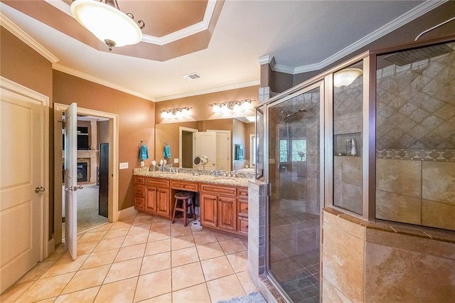 bathroom with vanity, an enclosed shower, tile patterned floors, and crown molding