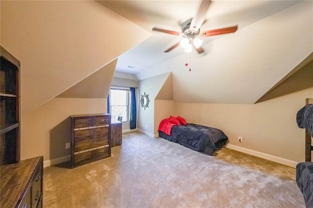 carpeted bedroom with vaulted ceiling and ceiling fan