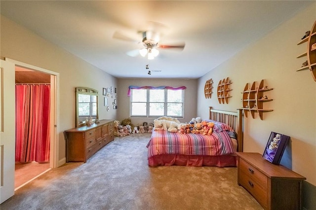 bedroom with light colored carpet and ceiling fan