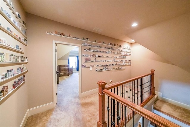 corridor featuring light colored carpet