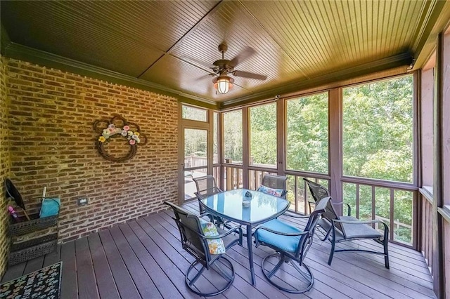 unfurnished sunroom with ceiling fan and wooden ceiling