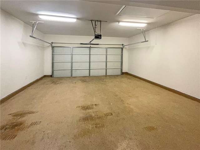 garage with baseboards and a garage door opener