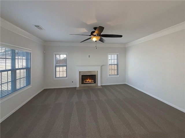 unfurnished living room with visible vents, ornamental molding, dark carpet, and baseboards