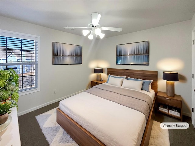 bedroom with ceiling fan and baseboards