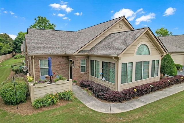 1402 Silver Summit Dr SE, Conyers, GA 30094 - rear view of house featuring roof with shingles, a yard, and brick siding