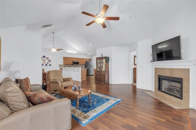 1402 Silver Summit Dr SE, Conyers, GA 30094 - living room featuring a ceiling fan, dark wood-style floors, a fireplace, and high vaulted ceiling