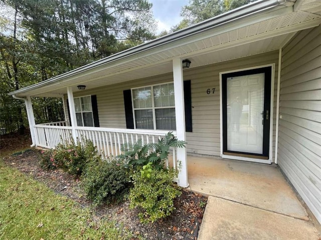 view of exterior entry featuring a porch