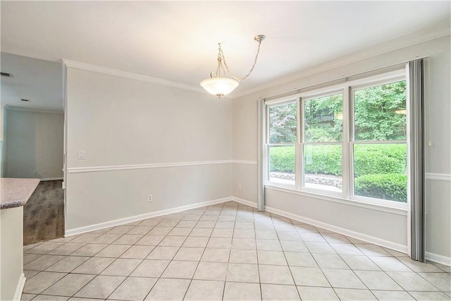 unfurnished room with crown molding, baseboards, and light tile patterned floors