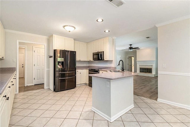 kitchen featuring black appliances, a sink, ceiling fan, ornamental molding, and a peninsula