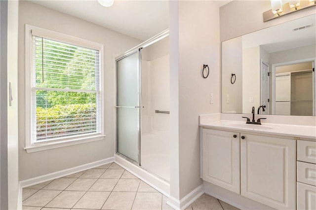full bath featuring baseboards, a stall shower, tile patterned floors, and vanity