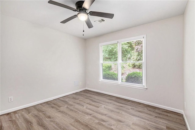 unfurnished room with baseboards, wood finished floors, and ceiling fan