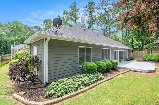 rear view of house with a wooden deck and a chimney