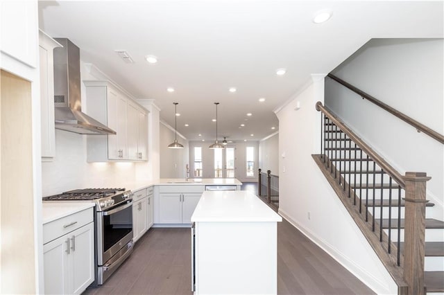 352 Olmstead Way Unit 28, Alpharetta, GA 30022 - kitchen featuring stainless steel range with gas stovetop, wall chimney range hood, a peninsula, light countertops, and dark wood-style flooring