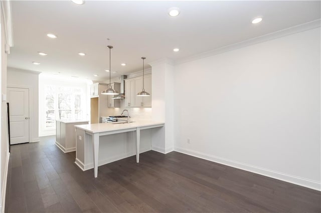 352 Olmstead Way Unit 28, Alpharetta, GA 30022 - kitchen with wall chimney range hood, light countertops, recessed lighting, dark wood-style floors, and a peninsula