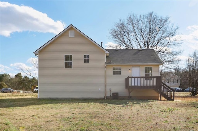 rear view of house featuring a yard and central air condition unit