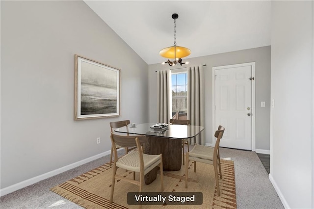 dining space with lofted ceiling, carpet floors, and an inviting chandelier