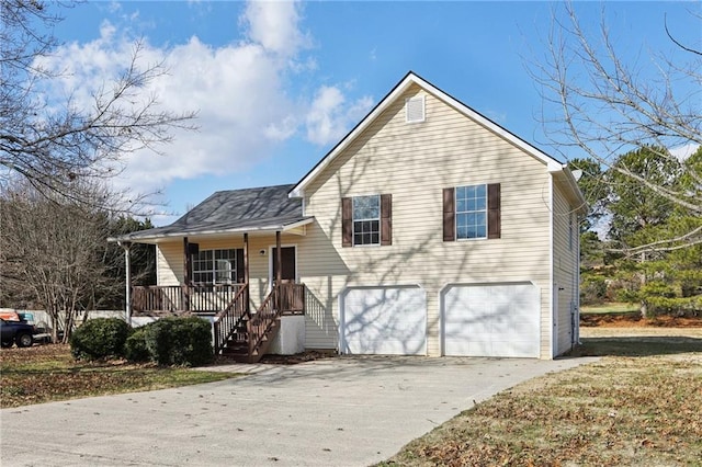 tri-level home with a porch and a garage