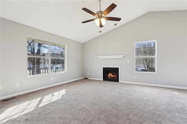 unfurnished living room featuring carpet, ceiling fan, and lofted ceiling