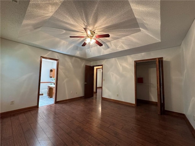 3436 Finglas Dr, Marietta, GA 30008 - unfurnished bedroom with a textured ceiling, baseboards, dark wood-style flooring, and a ceiling fan