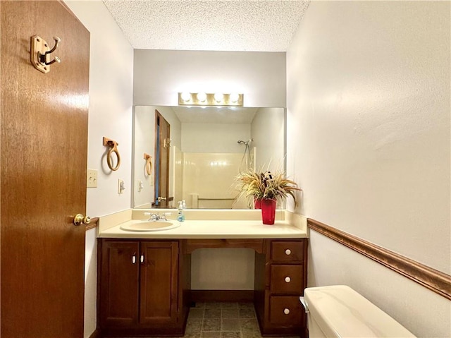 3436 Finglas Dr, Marietta, GA 30008 - bathroom featuring vanity, a shower, a textured ceiling, and toilet