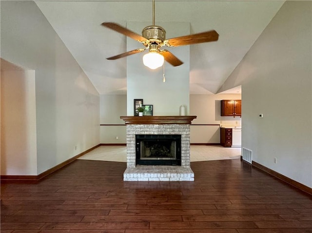 3436 Finglas Dr, Marietta, GA 30008 - unfurnished living room featuring vaulted ceiling, light wood-type flooring, a ceiling fan, baseboards, and a brick fireplace