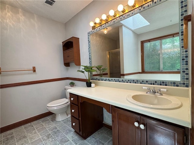 3436 Finglas Dr, Marietta, GA 30008 - full bath with vanity, a textured ceiling, a shower stall, toilet, and a skylight