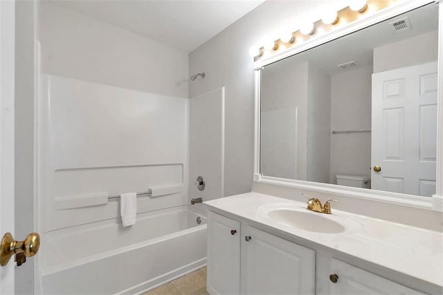 bathroom with visible vents, toilet, vanity, and washtub / shower combination