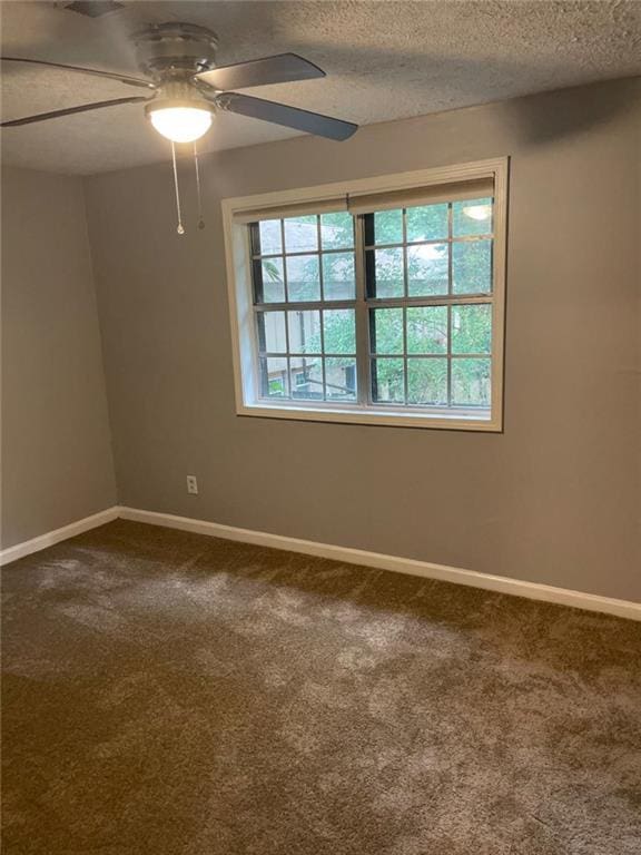 1150 Rankin St Unit D1, Stone Mountain, GA 30083 - spare room featuring a ceiling fan, dark colored carpet, and a textured ceiling