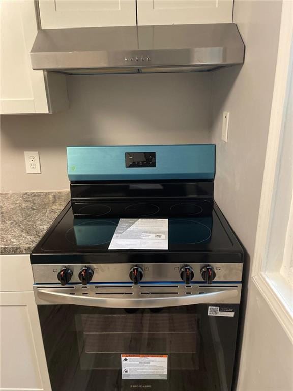 1150 Rankin St Unit D1, Stone Mountain, GA 30083 - kitchen featuring electric stove, exhaust hood, white cabinetry, and stone countertops