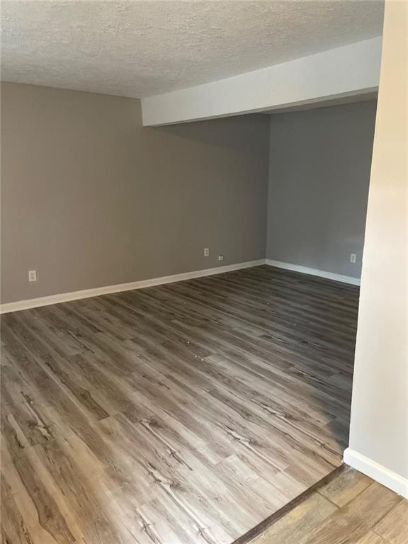 1150 Rankin St Unit D1, Stone Mountain, GA 30083 - spare room with a textured ceiling and wood finished floors