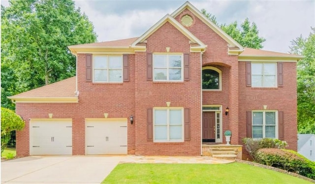 10950 Glenhurst, Duluth, GA 30097 - view of front of house featuring concrete driveway, brick siding, and a front yard