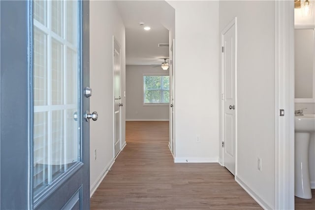 hallway with hardwood / wood-style floors