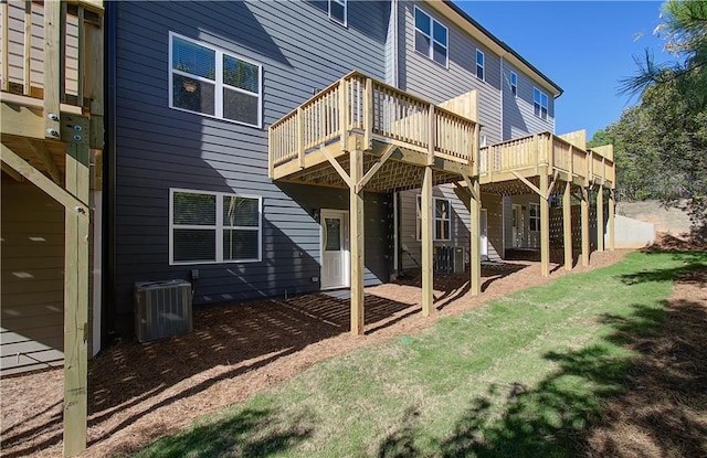 rear view of property with a wooden deck and central AC unit