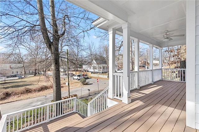 wooden terrace with ceiling fan and a porch