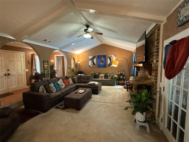 2671 Club Forest Ct SE, Conyers, GA 30013 - carpeted living area featuring arched walkways, ceiling fan, lofted ceiling, and a fireplace