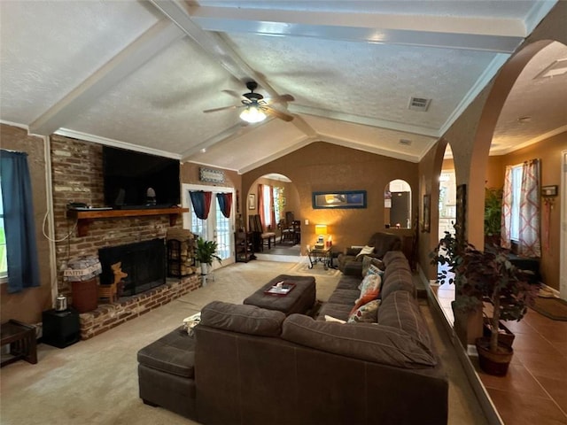 2671 Club Forest Ct SE, Conyers, GA 30013 - carpeted living area featuring arched walkways, plenty of natural light, a ceiling fan, a brick fireplace, and crown molding