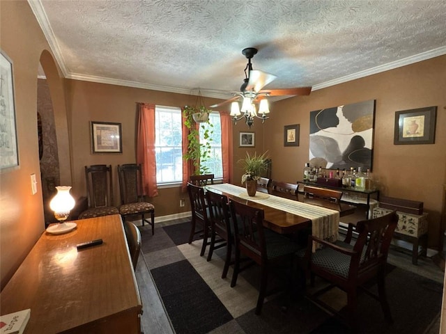2671 Club Forest Ct SE, Conyers, GA 30013 - dining space with ceiling fan, arched walkways, ornamental molding, a textured ceiling, and baseboards