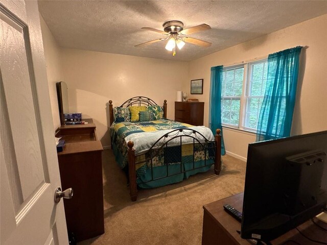 2671 Club Forest Ct SE, Conyers, GA 30013 - carpeted bedroom featuring a textured ceiling and ceiling fan