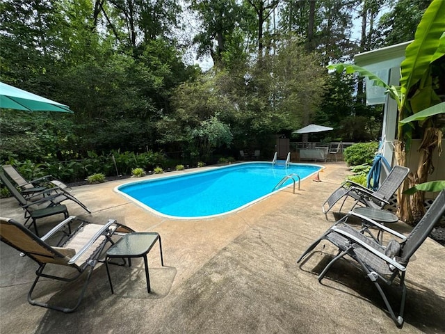 2671 Club Forest Ct SE, Conyers, GA 30013 - outdoor pool featuring a patio area and view of scattered trees