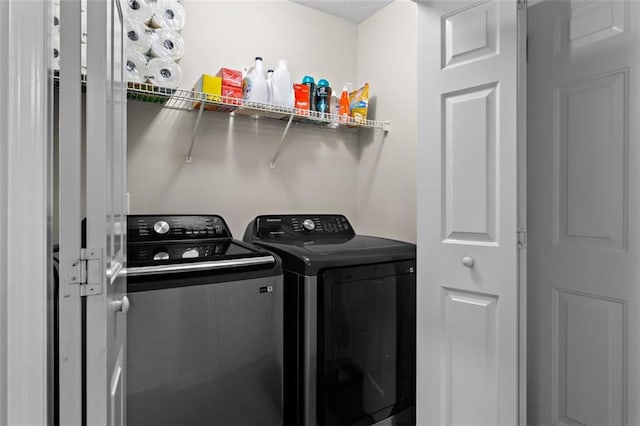 washroom featuring washing machine and dryer and laundry area