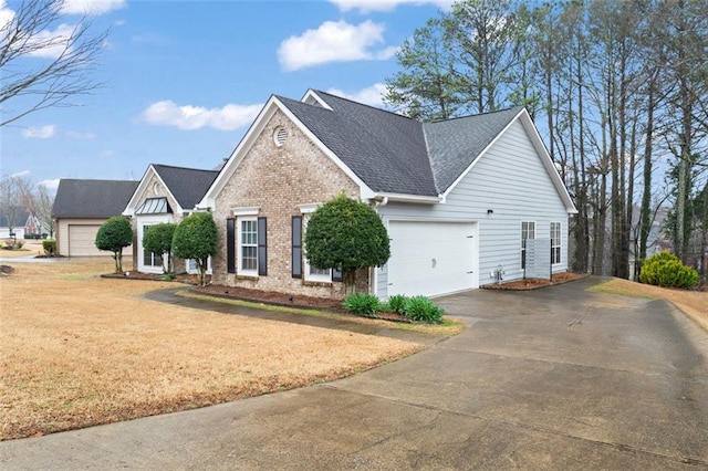 view of front of home with brick siding, an attached garage, a front lawn, roof with shingles, and driveway