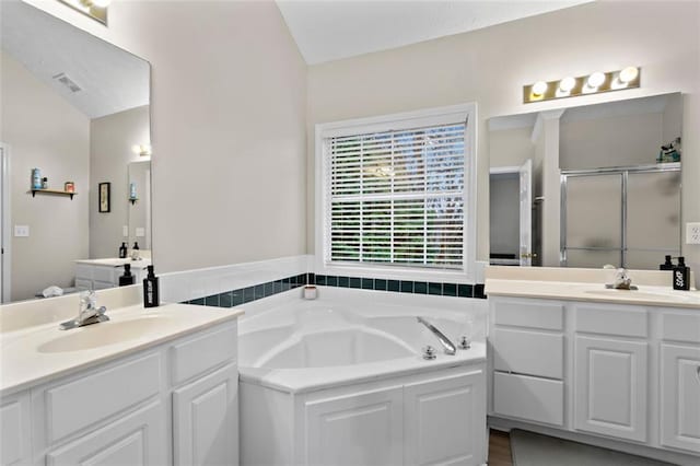 bathroom featuring a sink, visible vents, a bath, and a shower stall