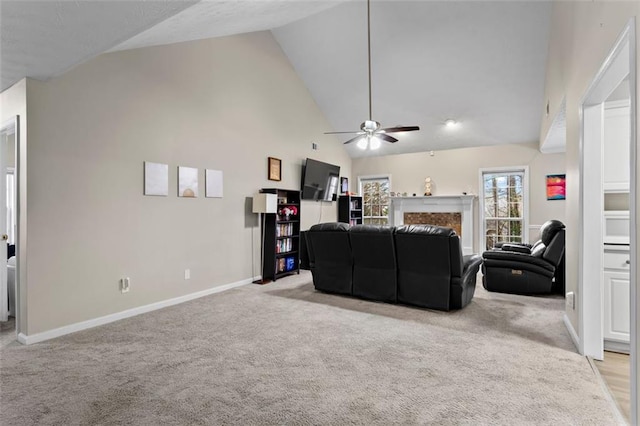 living area featuring high vaulted ceiling, baseboards, light colored carpet, and a fireplace